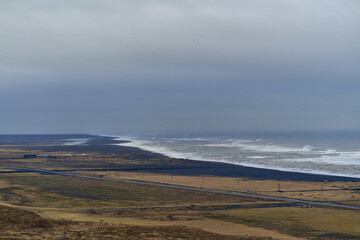 Ocean waves crashing on black sand beach in iceland