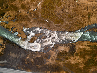 Turquoise glacial river flowing through a vast icelandic landscape