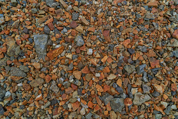 Background showing many colorful stones forming a gravel surface