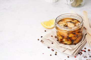 Jar with pickled mussels on white background