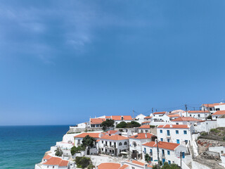 A charming village perched on a cliff overlooking the sparkling blue ocean