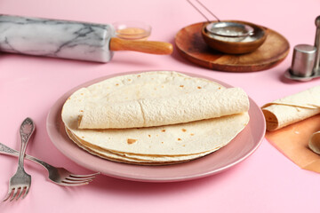 Plate with thin lavash on pink background