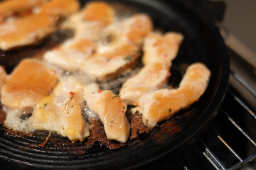 Chicken strips sizzling in a pan ready for a delicious meal