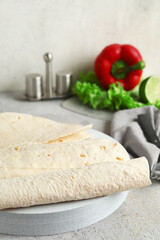 Board with fresh lavash on table, closeup