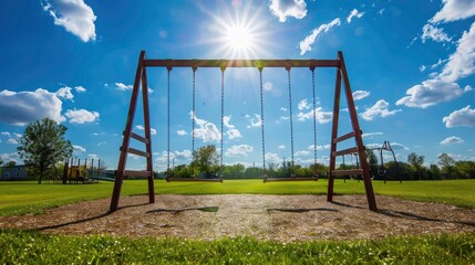 Fototapeta premium A playground with a swing set under a bright blue sky.