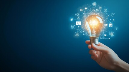 Hand holding light bulb with digital icons and network connection on blue background, representing innovation in technology for business or education. High quality, professional photography