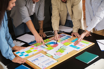 Colleagues working on business plan at table in office, closeup