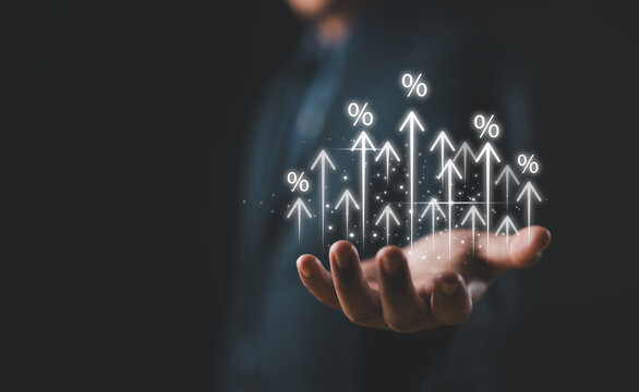Businessman showing percentage icons and up arrow icons with graph indicators. Concept of financial interest rates and mortgage rates. Interest Rates Stocks Finance Ratings Mortgage Rates.