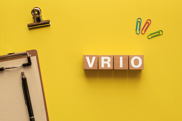 There is wood cube with the word VRIO. It is an abbreviation for Value, Rarity, Inimitability,...