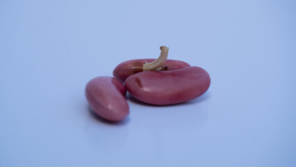 3 sprouted red beans. Pile of pinkish beans with some displaying the first signs of sprouting.