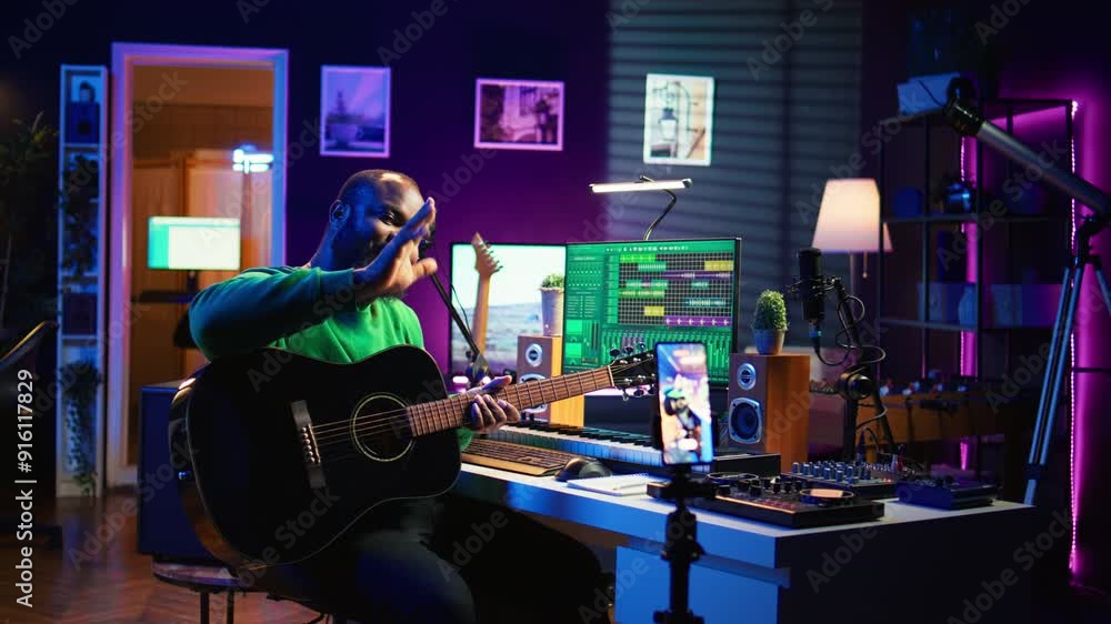 Poster Professional composer teaching guitar lessons online on master class, recording himself playing acoustic instrument accords and explaining notes for tutorial. Young musician making vlogs. Camera B.
