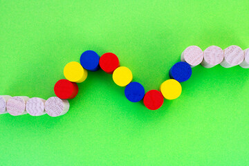 Row of wooden cylinders with several of them in different colors