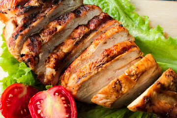 close up of sliced ​​grilled chicken breast with vegetables