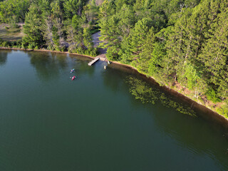 kayak.s on calm northern lake in summer