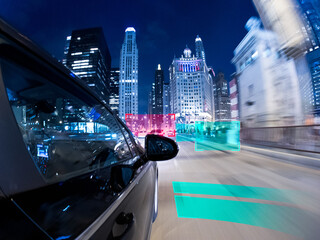 Concept of a Driverless car driving towards a futuristic cityscape, Chicago, Illinois, USA