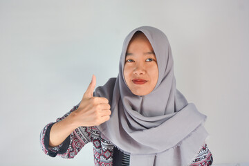 Young cheerful happy smiling pleasant successful employee business woman in her 20s wearing casual brown classic jacket showing okay okay gesture isolated on plain pastel light pink background studio