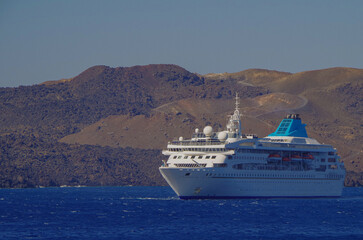 Classic cruiseship cruise ship liner Nefeli anchoring offshore of Santorini Oia Island during...