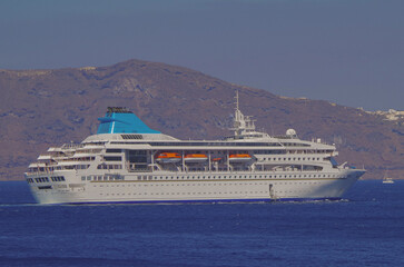 Classic cruiseship cruise ship liner Nefeli anchoring offshore of Santorini Oia Island during Summer Greek Islands aegean Greece cruising