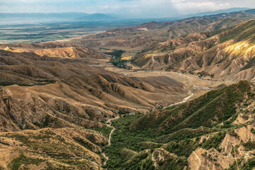 View from above of a winding mountain gorge. Mountain landscapes of Kyrgyzstan