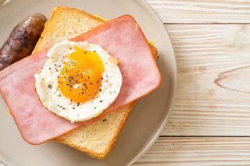 bread toasted cheese topped ham and fried egg with pork sausage