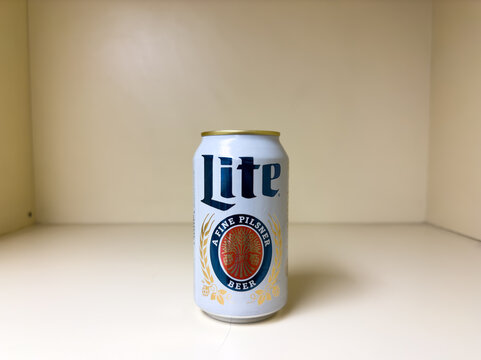 Miller Lite Beer Can on Cream-Colored Shelf with Simple Background

