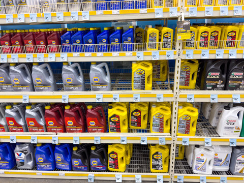 Motor Oil Containers on Store Shelf in Automotive Section

