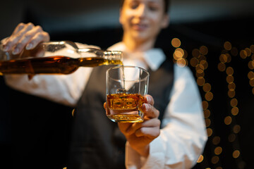 Barwoman pouring whiskey whiskey glass..