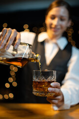 Barwoman pouring whiskey whiskey glass..