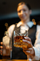 Barwoman pouring whiskey whiskey glass..