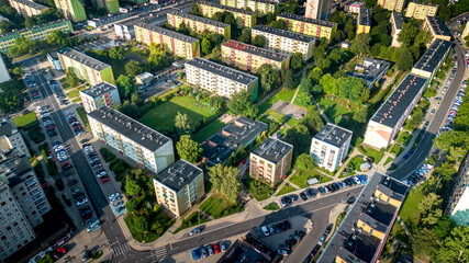 Aerial view of residential neighborhood with colorful apartment buildings and green spaces in a city during daylight
