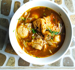 meatballs with spicy chicken soup sprinkled with sliced celery leaves