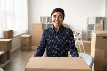 Portrait of successful small business owner holding big carton box, manage orders, selling goods...
