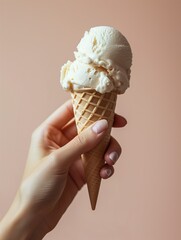 Handheld Indulgence: Vanilla Ice Cream Cone on Pastel Background