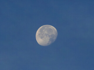 Full moon over blue sky