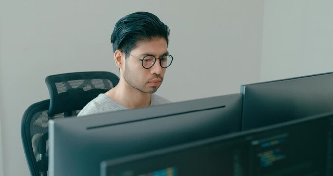 Young adult Asia male freelance eyeglasses typing write prompt AI bot IT app smart program nomad, video game, terminal with coding, user interface, designer, big data center on desktop computer.