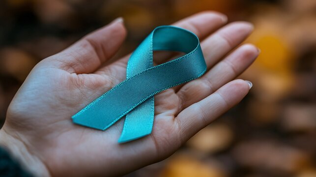 Teal ribbon on a woman's hand, showcasing support for ovarian cancer and PCOS awareness, with a focus on health advocacy.