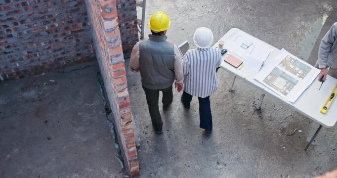 Above, handshake and people on construction site for plan, collaboration or technology at table. Contractor, welcome and woman with tech for information, brainstorming or architect design in morning