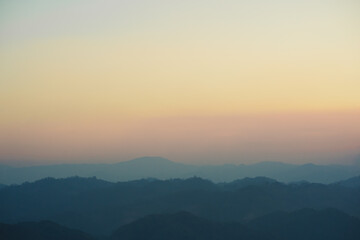 Obraz premium landscape and travel concept with sunset and twilight sky with layer of mountain