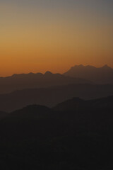 nature traveling with orange sky and layer of mountain with sunrise background