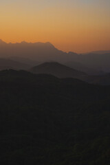 nature traveling with orange sky and layer of mountain with sunrise background