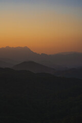 nature traveling with orange sky and layer of mountain with sunrise background