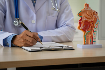A male doctor sits at the table, explaining the respiratory and digestive systems, highlighting the...