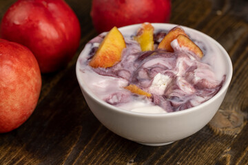 natural yogurt in a white bowl with fruits