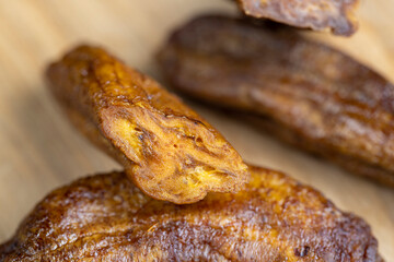 dried small bananas on a wooden board