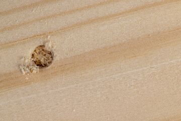 metal drill bit and pine wood board during operation
