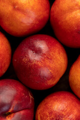 a large number of ripe soft nectarine fruits on the table