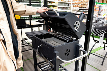 Outdoor modern black grill on display in a retail store.