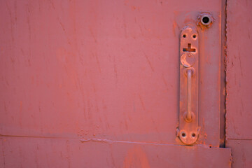 Pink plaster. Door handle. Backgrounds and textures