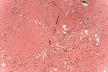 Pink cracked plaster texture. Close-up