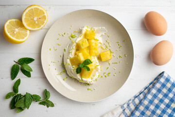 Delicious dessert with fresh pineapple and whipped cream on a table with Christmas decoration.